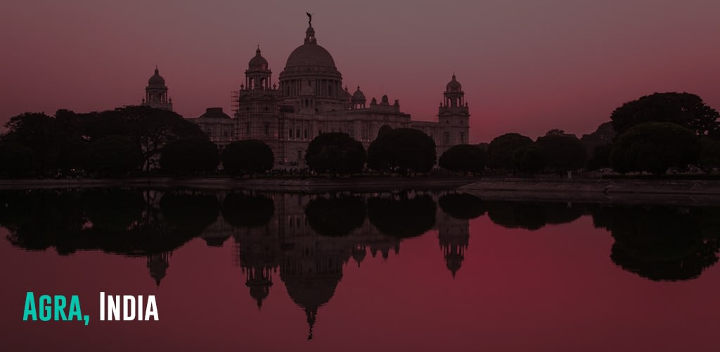 The Taj Mahal during sunset reflecting on the body of water beside it.