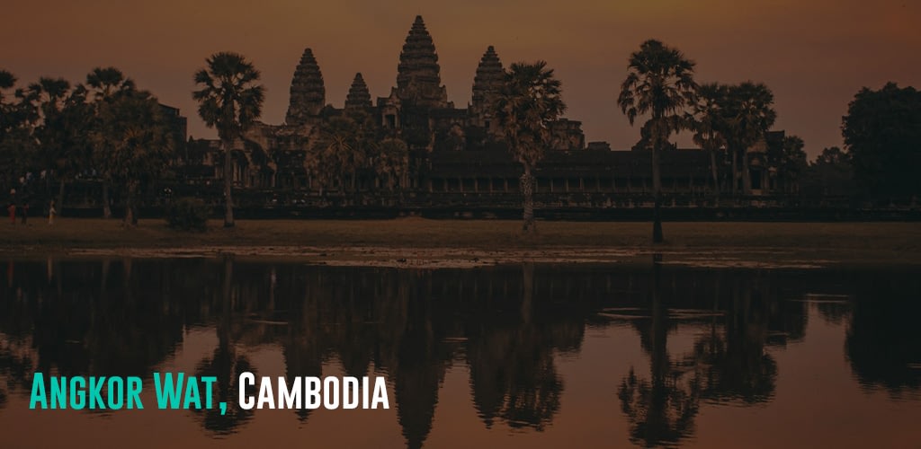 the temples reflecting on a body of water during sunset