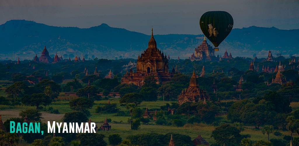 a hot air balloon flying over ancient temples