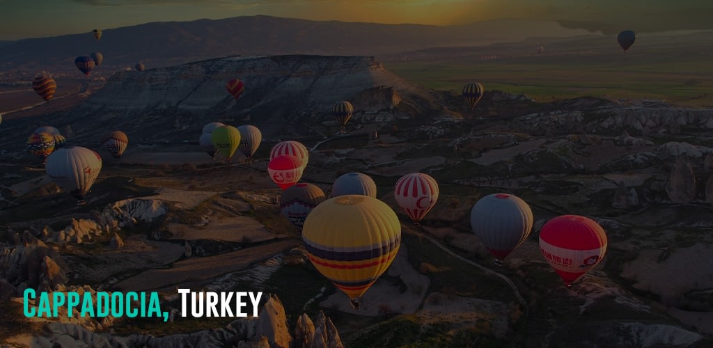 colorful hot air balloons flying over a rocky terrain