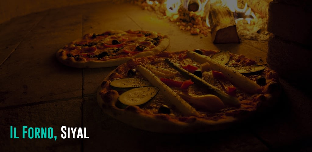 Pizza being cooked in a brick oven