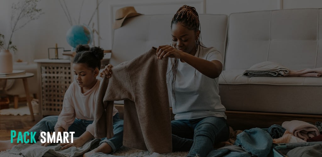 a mother and daughter folding clothes