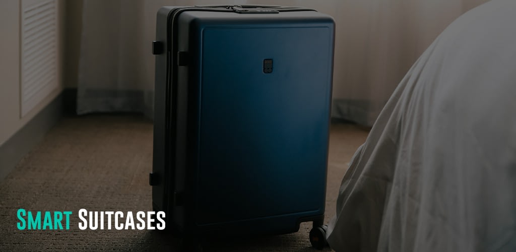 a blue suitcase sitting on the floor next to a bed