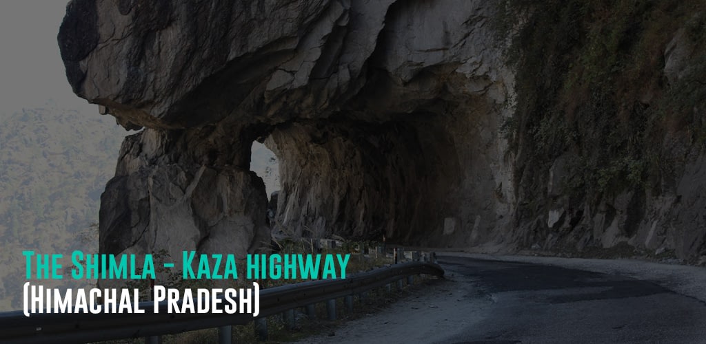 road way going through a rock with a manmade tunnel through it