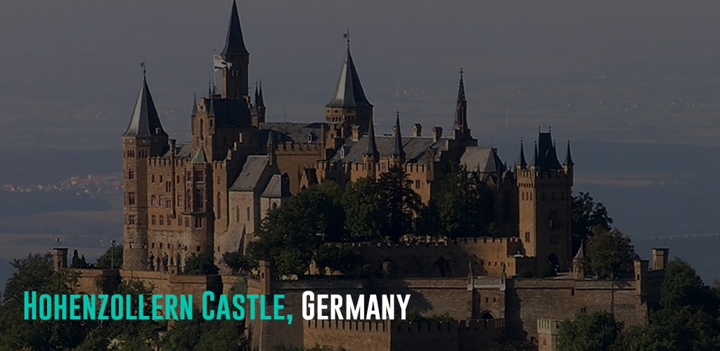 a brown and black castle on top of a mountain