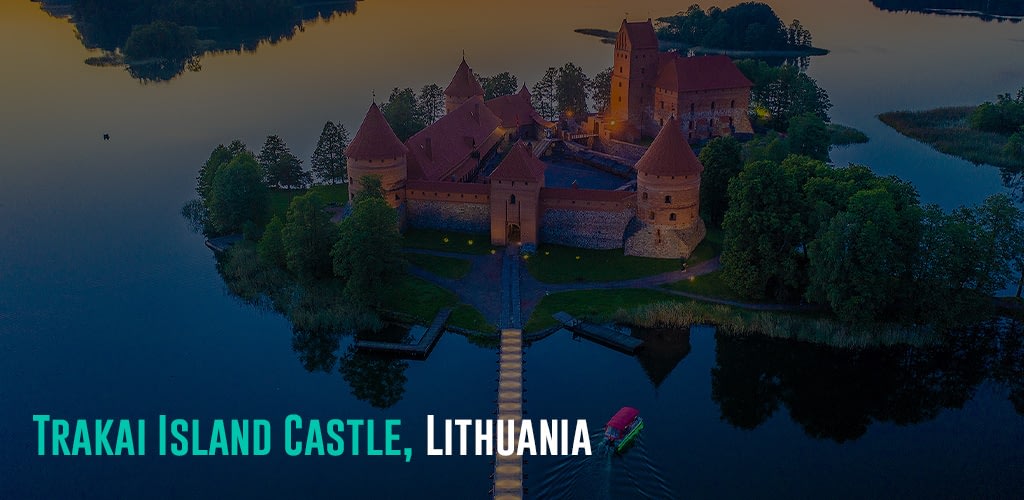 a brown and red castle on an island surrounded by a body of water