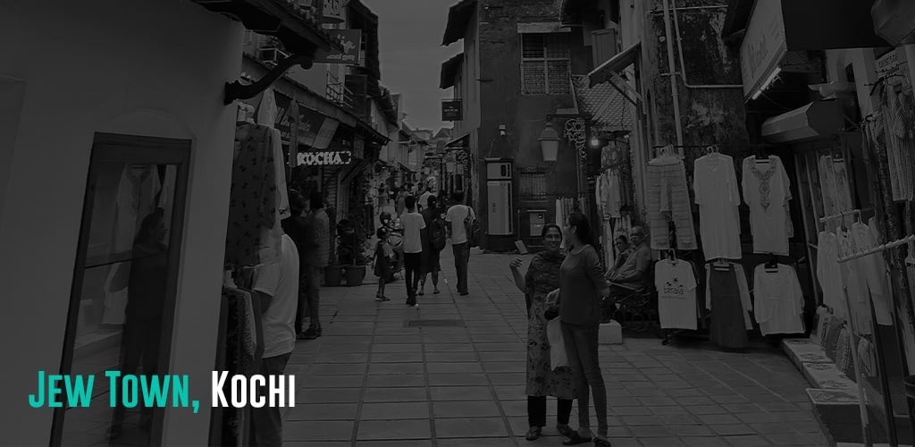 a street filled with shops and people walking by
