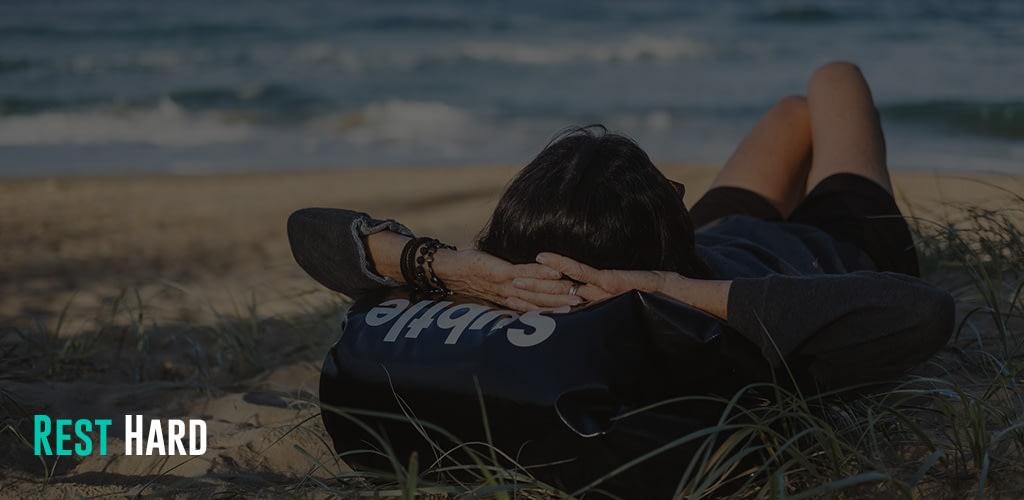 woman lying on grass front of sea