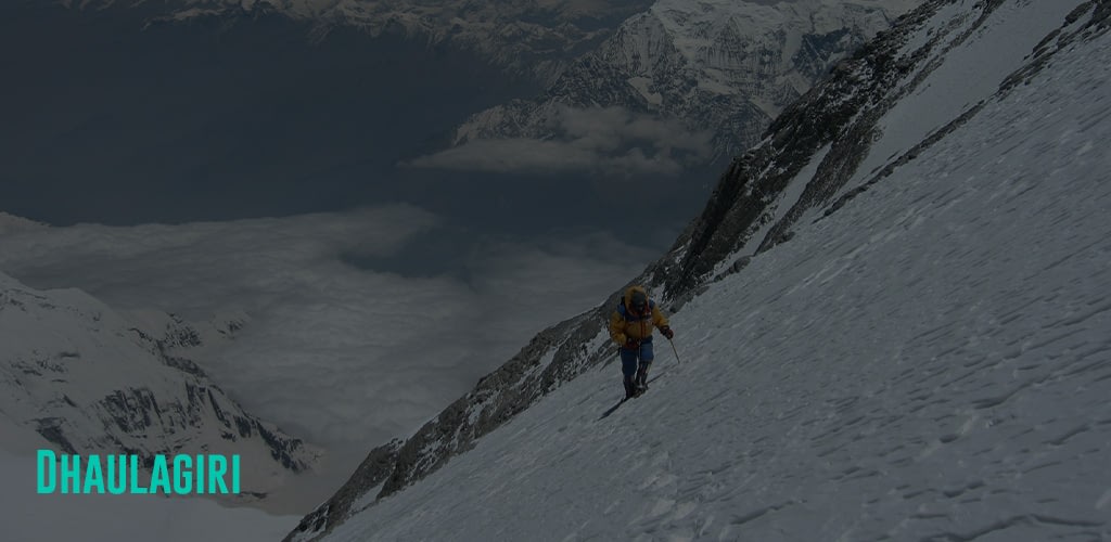a person hiking over a steep slope of snow