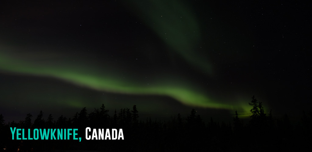 green hues of the northern lights coloring the dark skies.