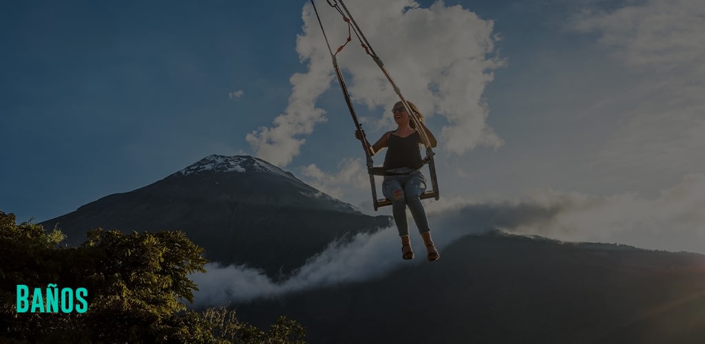A woman on the Swing At The End Of The World Located At Casa Del Arbol, The Tree House In Banos De Aqua Santa, Ecuador