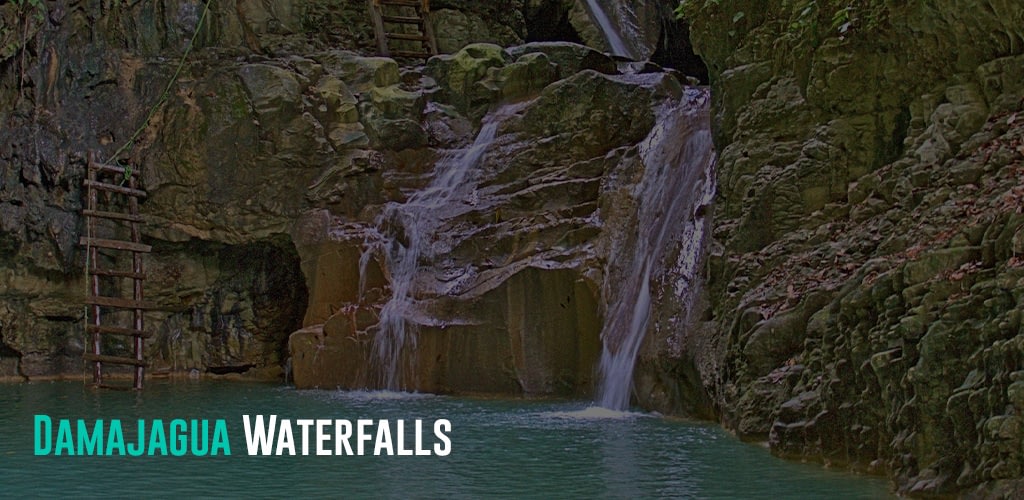 waterfalls with a beautiful turquoise water and ladders for tourists to climb up to slide down the waterfall.