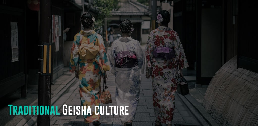 Three geishas walking in a street.