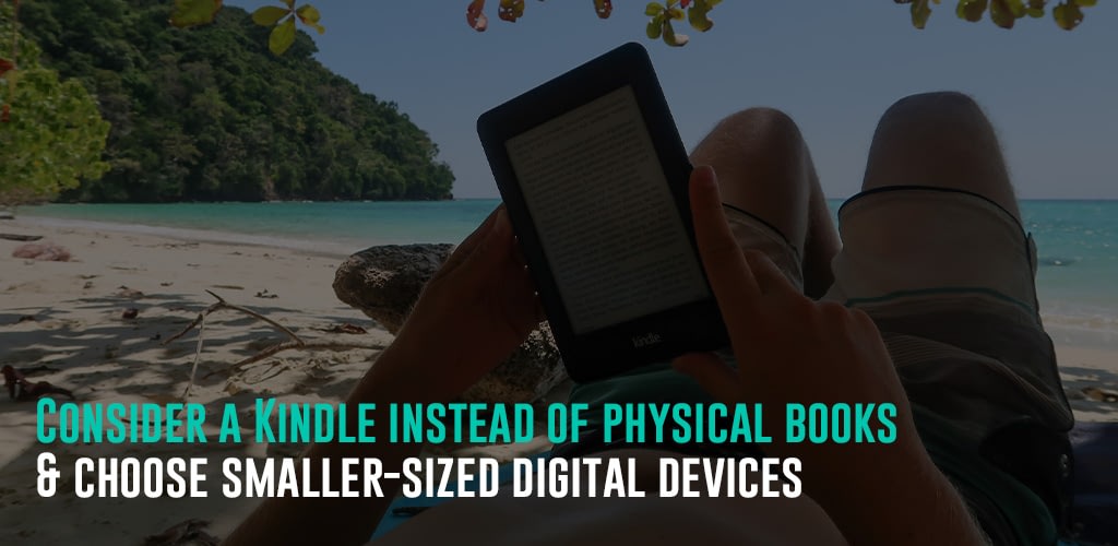 a man reading a kindle while on the beach