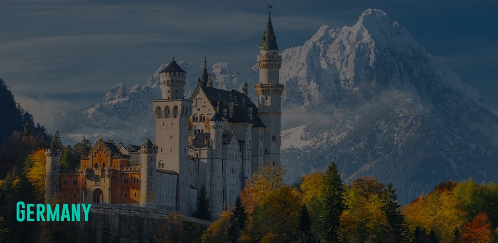 a view of the Neuschwanstein Castle and snowy mountains at the background