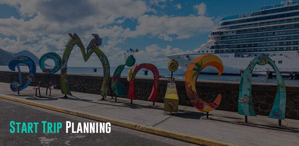 a letter shaped signage spelling out Dominica and a cruise ship behind