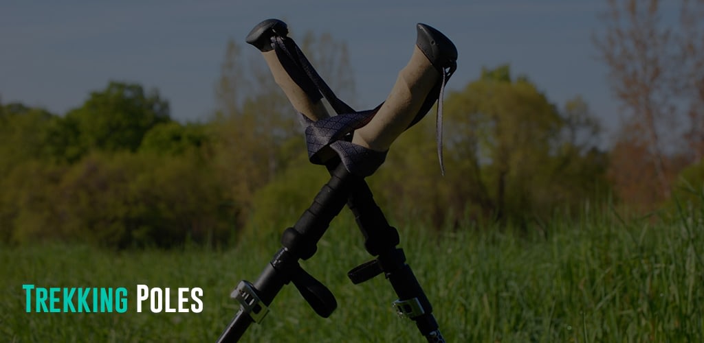 trekking poles stuck on the field of grass