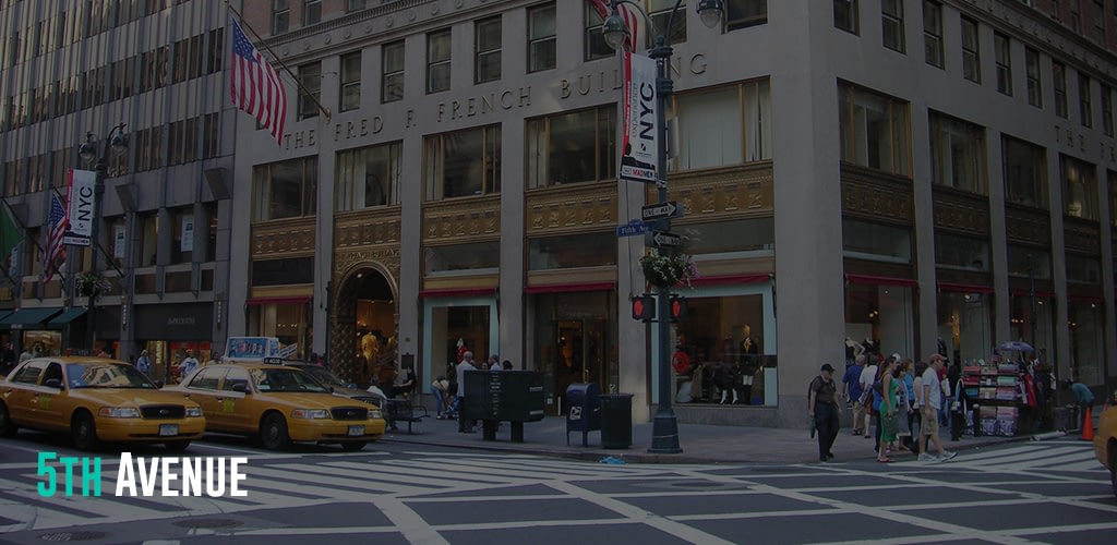 taxi's parked at the side of the street and people walking at 5th Avenue