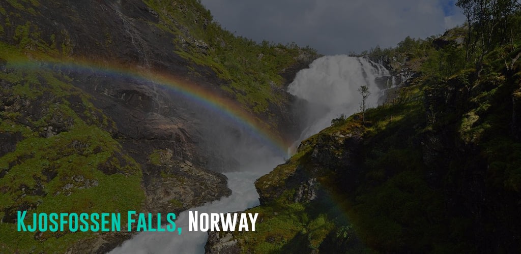 a shot of the Kjosfossen Falls with a rainbow forming over it.