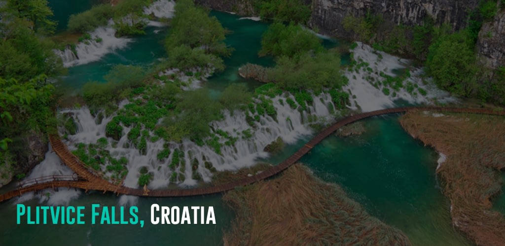 a bird's eye view of the Plitvice Falls with a foot bridge to let people pass through