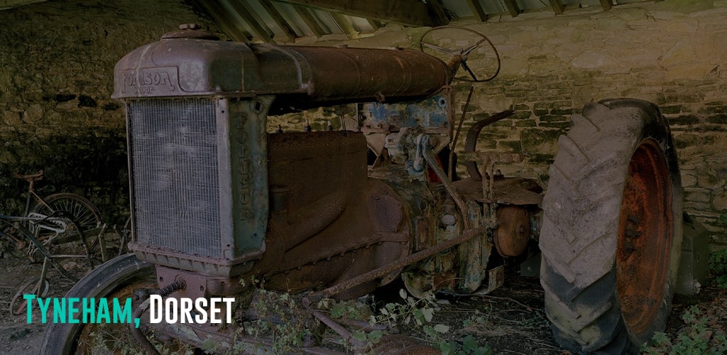 a very old tractor parked