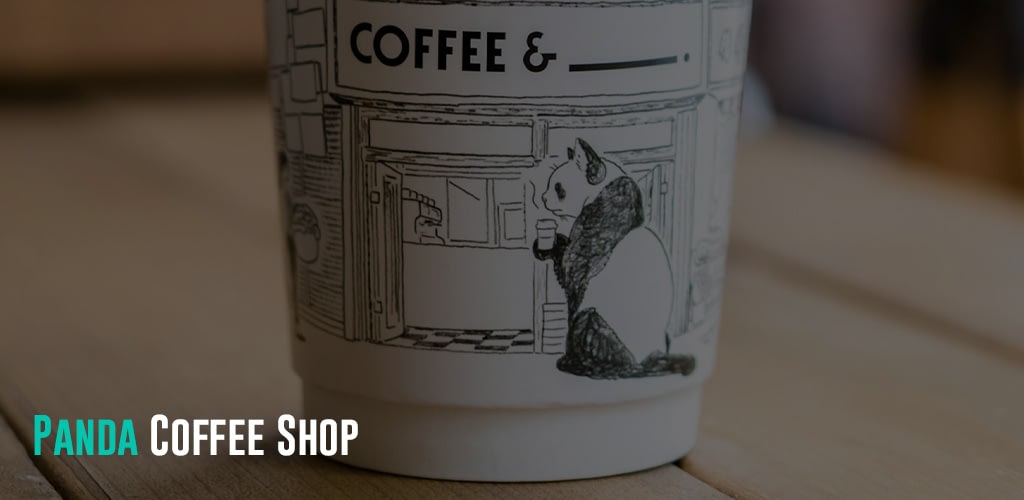 A paper cup with a drawn panda design